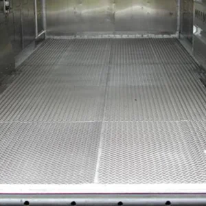 A flat floor option shown with textured rubber tiles inside a gooseneck trailer