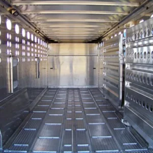 The interior of a gooseneck trailer with horizontal floor cleats running along the deck.