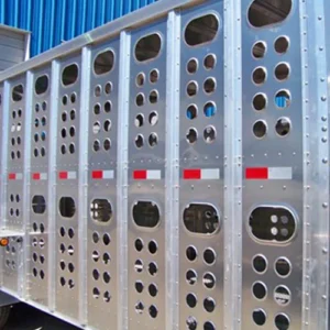 The right side of this gooseneck trailer shows hole punching on both the top and bottom of the trailer wall.