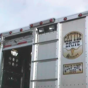 High-mounted red lights line the top of the trailer's back side