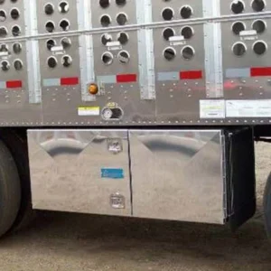 Silver tool boxes installed between the axles at the bottom of a trailer