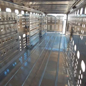 A triple-swing-gate setup inside a gooseneck trailer