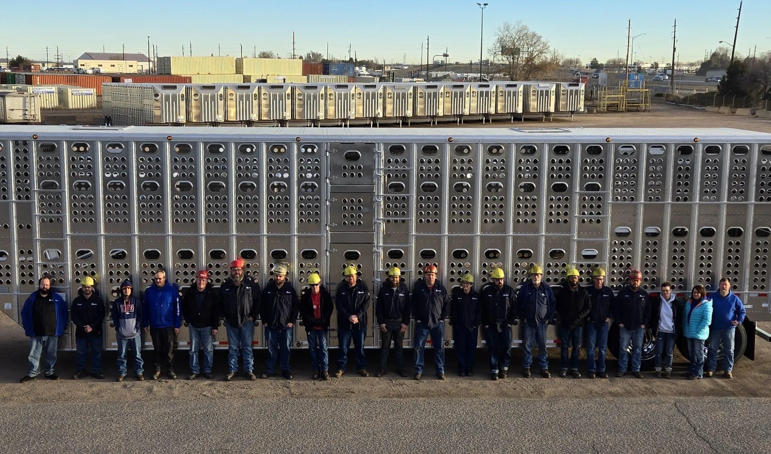 The Merritt Trailers Colorado team stands in front of a livestock trailer.